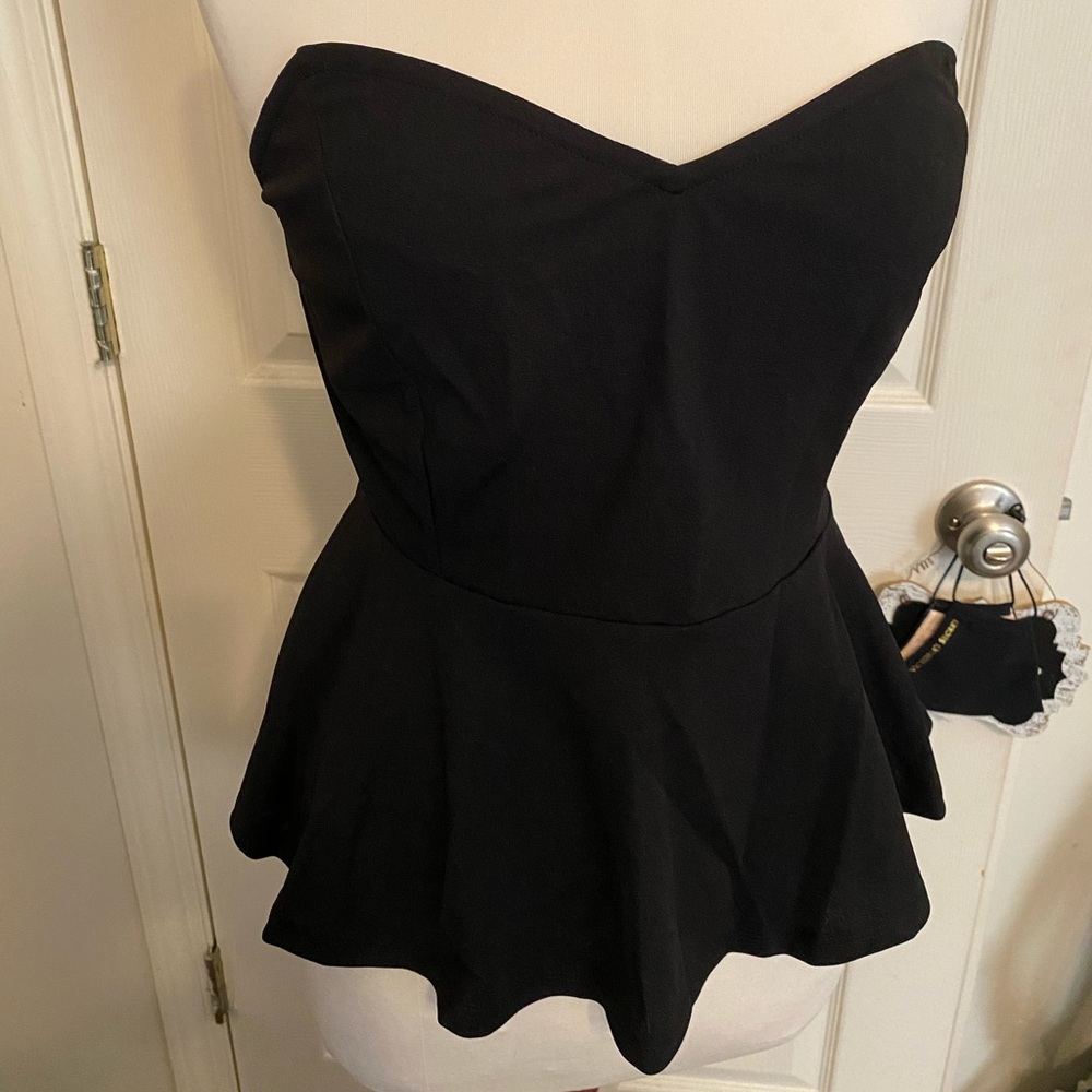 Black strapless flouncy top.